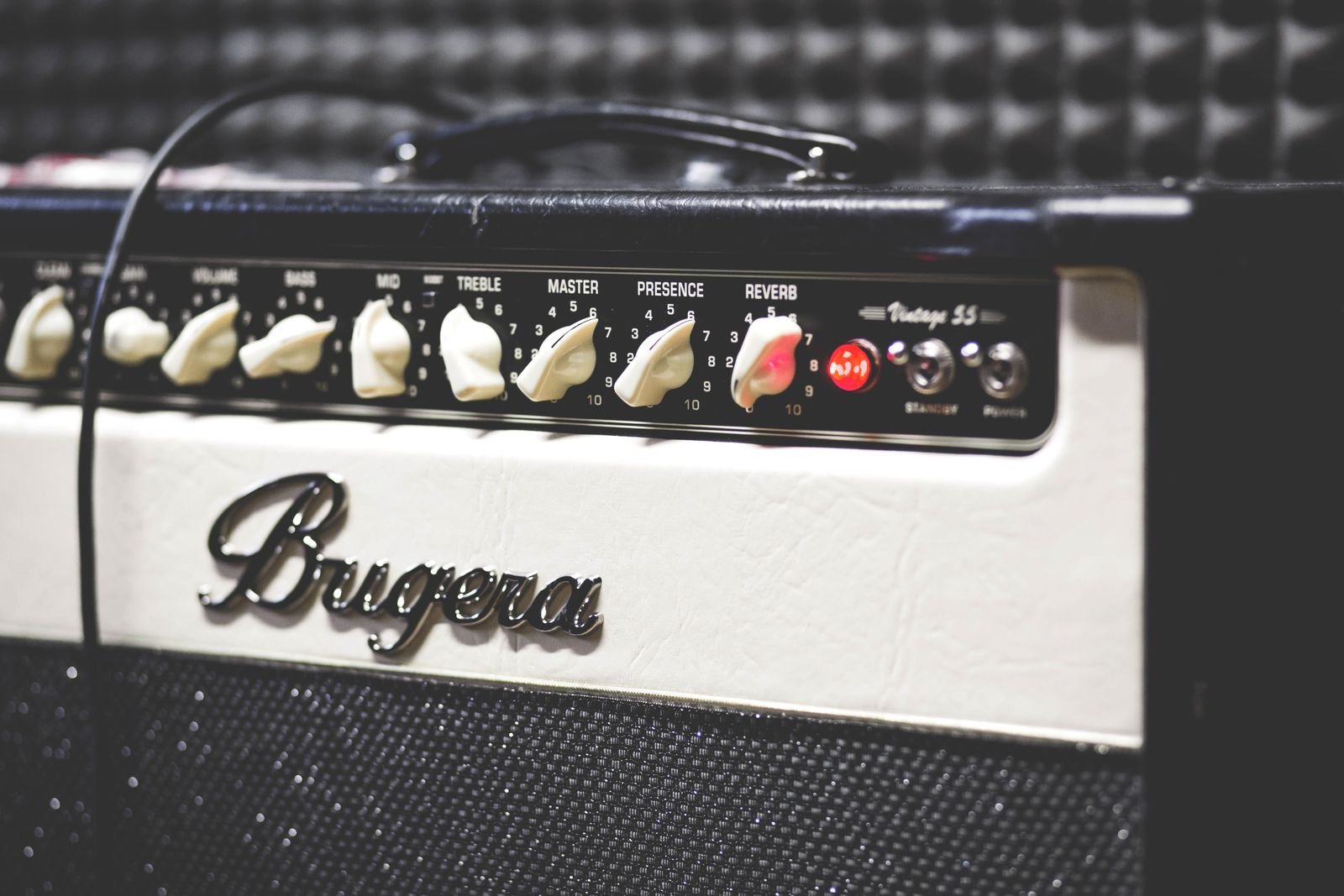 A guitar amplifier head photographed up close in dim light