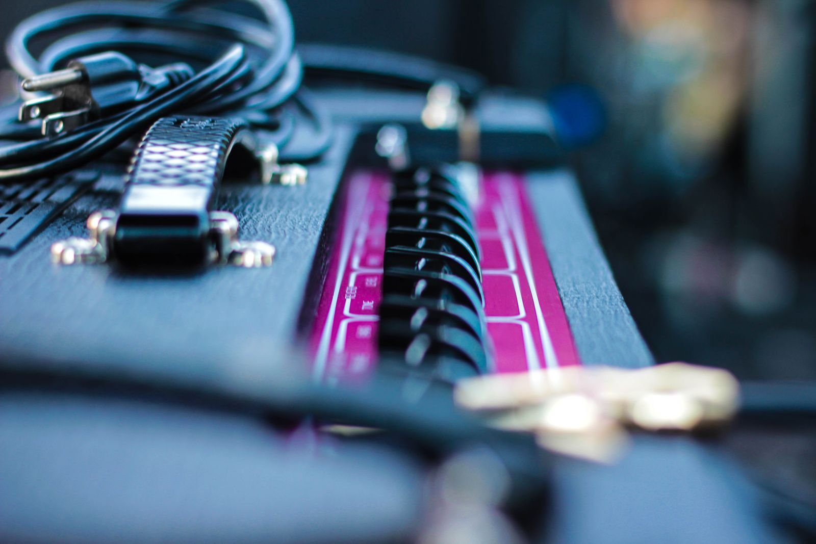An amplifier shot in close detail, knobs and grille visible