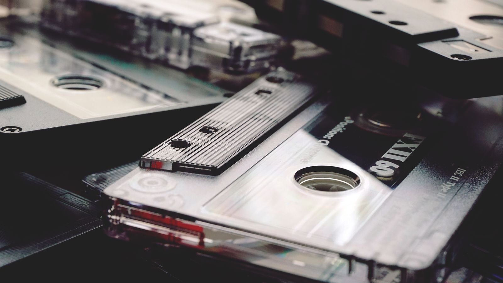 A stack of TDK and FXII cassette tapes piled together