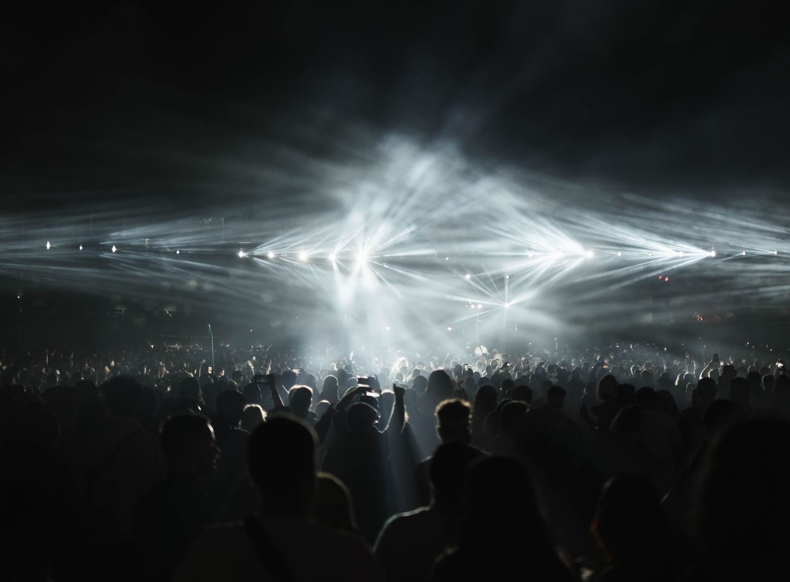 Dramatic stage and performance lit by harsh white light