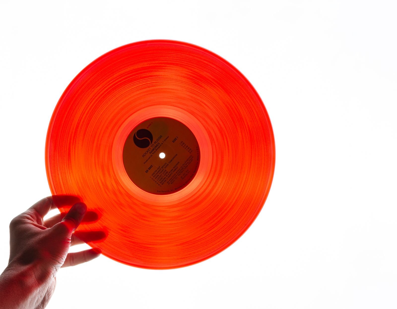 Close-up of a black vinyl record, grooves catching the light